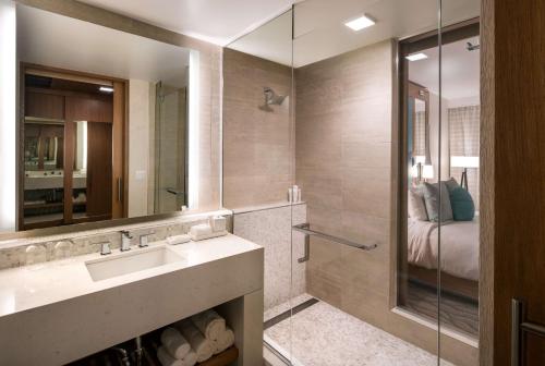 a bathroom with a sink and a shower at Paséa Hotel & Spa in Huntington Beach