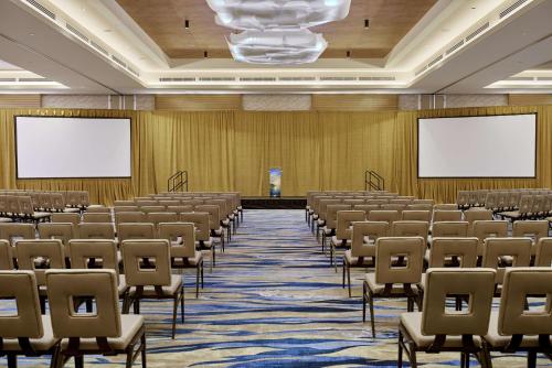 an empty lecture hall with chairs and screens at Paséa Hotel & Spa in Huntington Beach