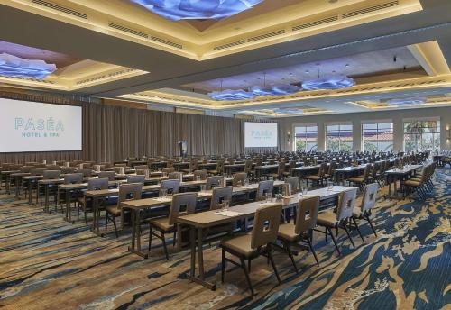 a large room with tables and chairs and a presentation at Paséa Hotel & Spa in Huntington Beach