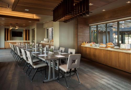 a dining room with a long table and chairs at Paséa Hotel & Spa in Huntington Beach