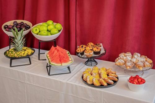 a table topped with bowls of fruit and other foods at Hotel Gamla Stan, BW Signature Collection in Stockholm