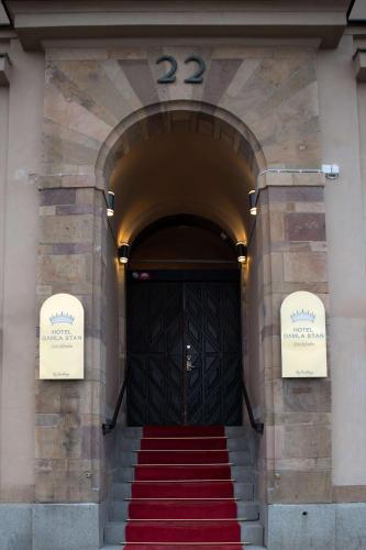 a black door with a red carpet in front at Hotel Gamla Stan, BW Signature Collection in Stockholm