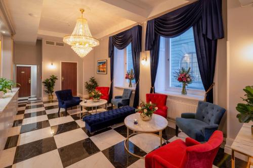 a lobby with chairs and tables and a chandelier at Hotel Gamla Stan, BW Signature Collection in Stockholm