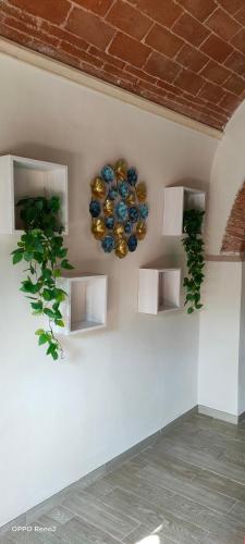 a wall with shelves with vases and plants on it at Il Nido Rustico in Ponsacco