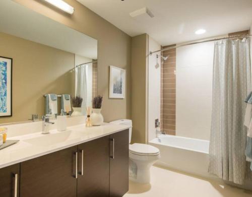 a bathroom with a sink and a toilet and a tub at National at Pentagon in Arlington