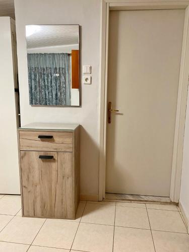 a bathroom with a mirror and a wooden door at Anastasia's House Νιγρίτα near Serres in Nigríta