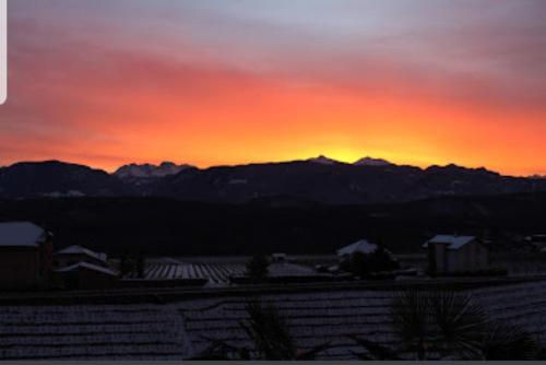 a sunset with the mountains in the background at Ansitz Strengherrnhof in Caldaro