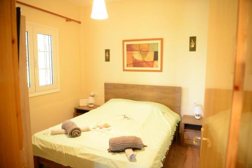 a small bedroom with a bed with white sheets at ZeusPlace Valentina's house Elatochori in Elatochori