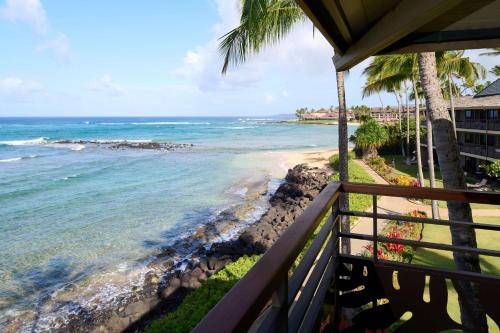 a view of the beach from the balcony of a resort at Koa Kea Resort on Poipu Beach in Koloa