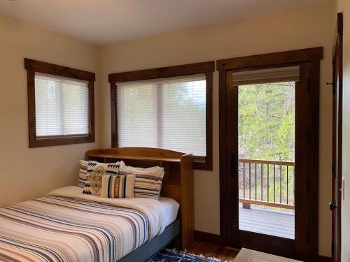 a bedroom with a bed and two windows at Family Friendly, Pet Friendly, New Build, 20 mi to Breckenridge - Lamplighter Lodge in Fairplay