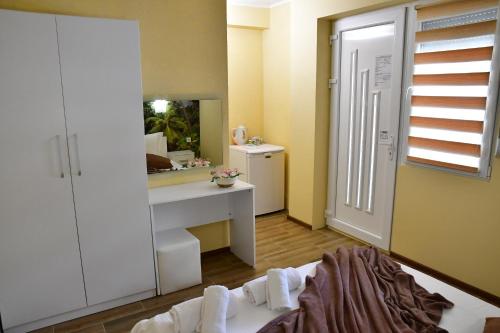 a bathroom with a sink and a mirror at VILLA IBIS THASSOS in Chrysi Ammoudia