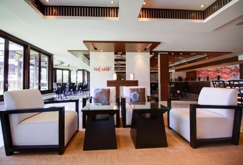 a store with white chairs and tables and windows at Koa Kea Resort on Poipu Beach in Koloa