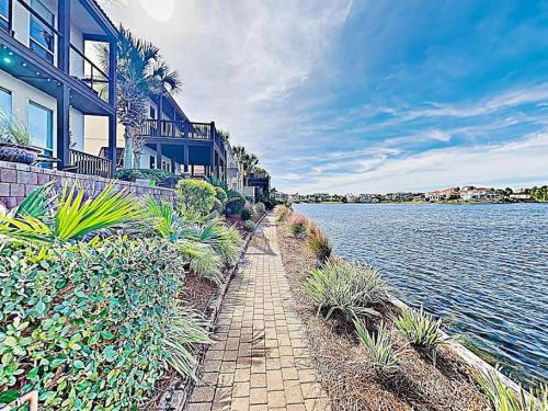 a brick walkway next to a lake with houses at Destiny Beach Villas #20A in Destin