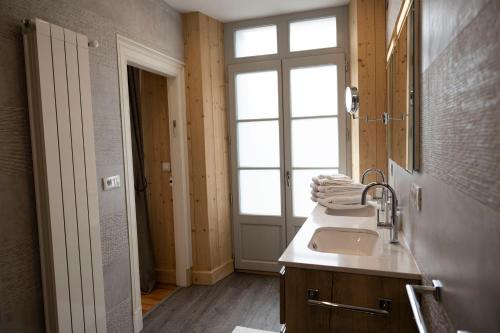 a bathroom with a sink and a window at LE 41 AVENUE FOCH in Luchon