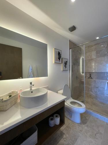 a bathroom with a sink and a toilet and a shower at New & Equipped Apartment Steps From The Beach With Pool Jacuzzi By Yeah in Playa del Carmen