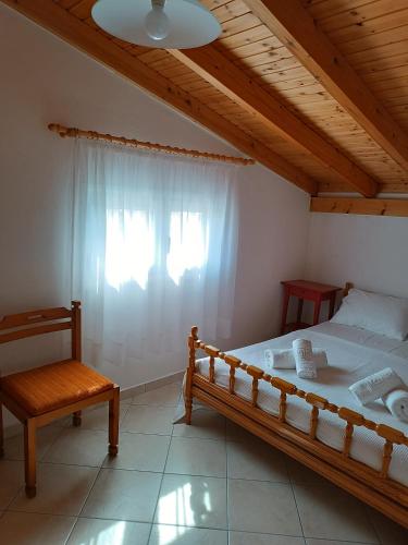 a bedroom with a bed and a window at Alpha apartment, Ireon Samos in Iraion