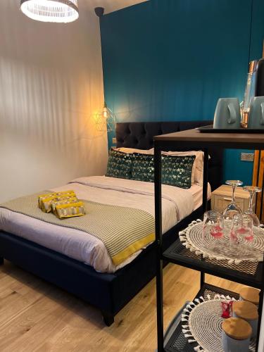 a room with two beds and a table with glasses at Flamingo Lodge in Torquay