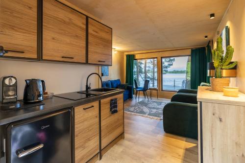 a kitchen and living room in a tiny house at Nad Narvią - dom na drzewie in Serock