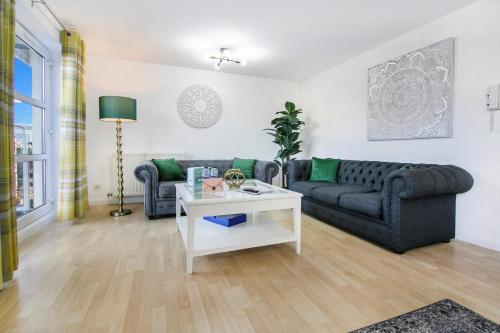 a living room with a couch and a table at Bannermill Place Lodge ✪ Grampian Lettings Ltd in Aberdeen