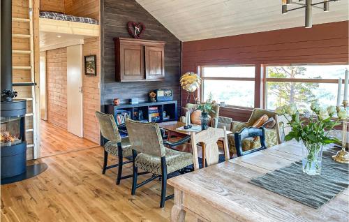 a kitchen and living room with a table and chairs at 3 Bedroom Awesome Home In Eggedal in Eggedal
