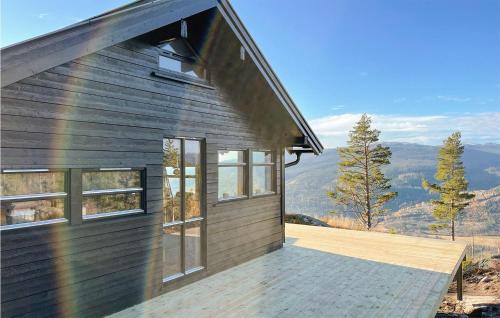 a house with a wooden deck with a rainbow at 3 Bedroom Awesome Home In Eggedal in Eggedal