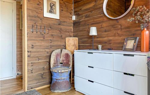 a bathroom with a wooden wall with a toilet in it at 3 Bedroom Pet Friendly Home In Eggedal in Eggedal