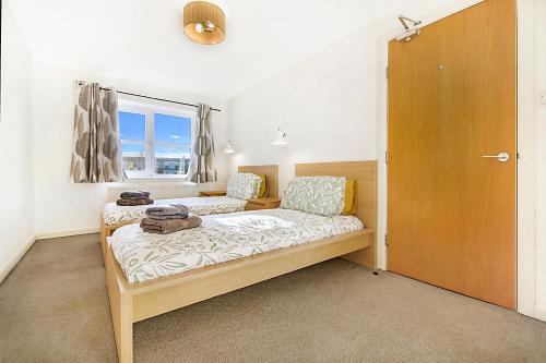a bedroom with two beds and a window at Bannermill Place Lodge ✪ Grampian Lettings Ltd in Aberdeen