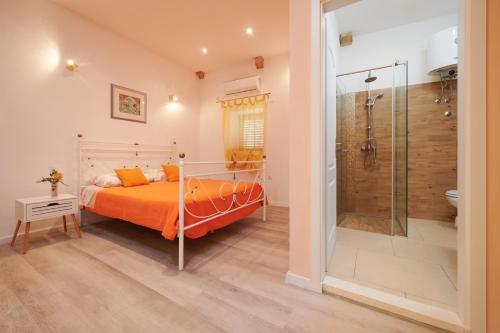 a bedroom with a bed and a shower at Palace Derossi in Trogir