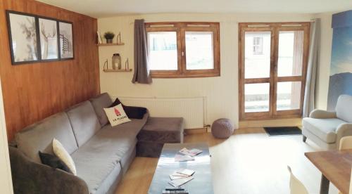 un salon avec un canapé et une table dans l'établissement Appartement 6/7 personnes pied des pistes à Plagne centre, à La Plagne
