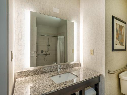 a bathroom with a sink and a mirror at Holiday Inn Express Gas City by IHG in Gas City