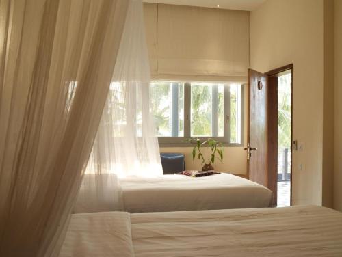 Postel nebo postele na pokoji v ubytování Knai Bang Chatt Resort