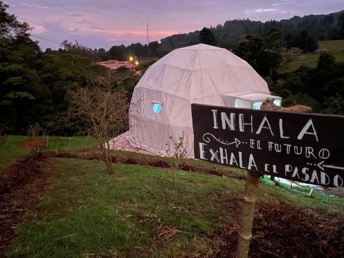 a sign in front of a iguana tent at Poas Volcano Observatory Lodge & Glamping in Poasito