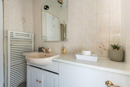 a white bathroom with a sink and a mirror at Abercorn Lodge Semi-Detached House in Edinburgh