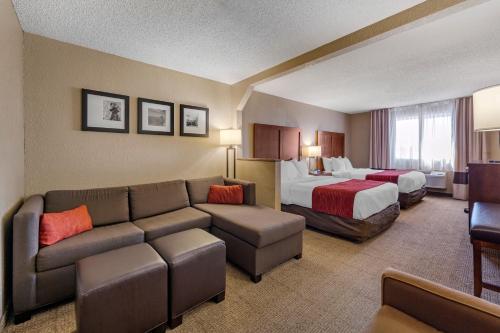 a hotel room with a couch and a bed at Comfort Inn & Suites Hays I-70 in Hays