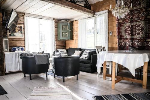 a living room with a table and a couch at Hugsnäset Semesterstugor och Fiske in Gällö