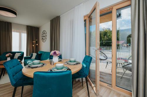 uma sala de jantar com mesa e cadeiras e uma varanda em Apartmán Hillside X34, Kubínska Hoľa em Dolný Kubín