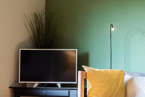 a flat screen tv sitting on a table next to a couch at Apartmán u Horynů - Sadová in Česká Třebová
