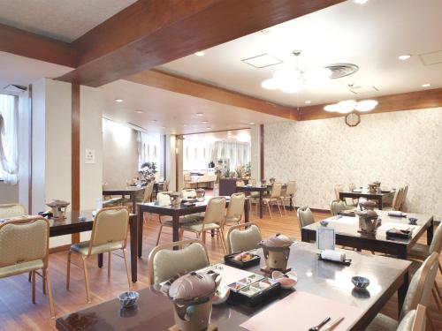 a restaurant with tables and chairs in a room at Kanko Hotel Yumotokan - Vacation STAY 60199v in Gero