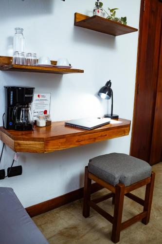 a wooden shelf on a wall with a coffee maker at Hotel con Corazón Granada in Granada
