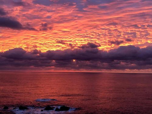 a sunset over the ocean with clouds in the sky at Takahira Base - Vacation STAY 61542v in Yakushima