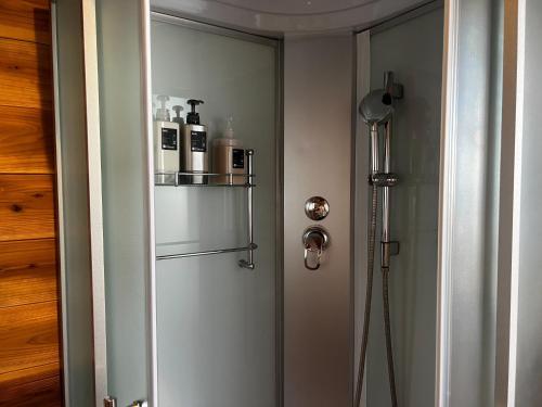 a bathroom with a door with a shelf on it at Glamping Village Leaf - Vacation STAY 65726v in Mashiki