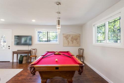 a pool table in a living room with avertisement for at Belaire BnB in Marble Falls