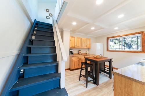 a blue staircase in a kitchen with a table at Belaire BnB in Marble Falls