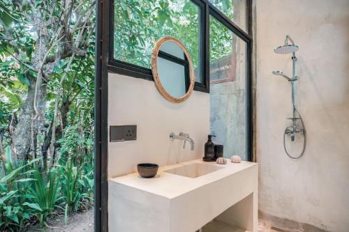 a bathroom with a sink and a mirror at Tao House Jungle Boutique Villas in Ahangama
