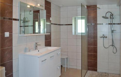 a bathroom with a shower and a sink and a mirror at 2 Bedroom Beautiful Home In Lolme in Lolme