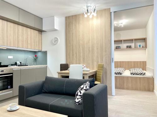 a living room with a couch and a kitchen at Explore Bratislava in Bratislava