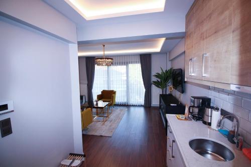 a kitchen with a sink and a living room at Home of Galataport in Istanbul