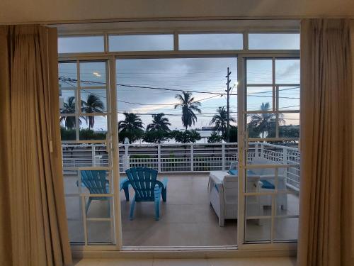 a view of a balcony with two chairs and a table at Bahia San Andres Hospedaje in San Andrés