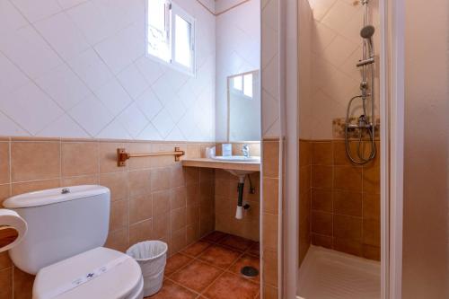a bathroom with a toilet and a sink and a shower at Hotel Copacabana Tarifa Beach in Tarifa