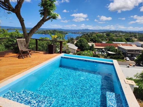 a pool on a deck with a view of the water at Bamboo Villa in Port Vila
